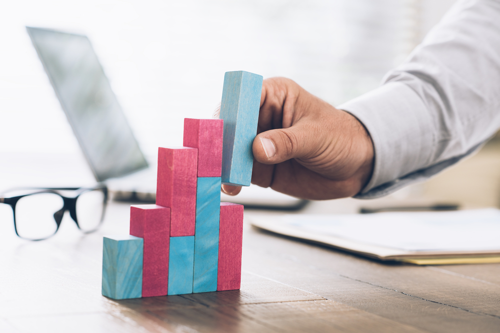 colored jenja blocks stacked to demonstrate growth